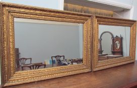 A pair of gilt gesso wall mirrors of rectangular form