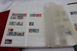 Three stocks books of stamps, including Elizabeth II regionals, world stamps, Postage Due,