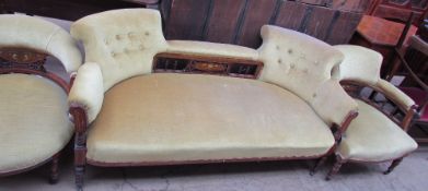 An Edwardian rosewood three piece salon suite comprising a three seater settee and two horseshoe