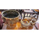 A large brass log basket together with a brass bowl held aloft by three elephants and a baluster