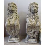 A pair of reconstituted stone lion statues,