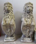 A pair of reconstituted stone lion statues,