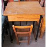 A school desk together with a child's chair