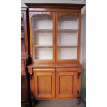 A Victorian oak bookcase with a moulded cornice above a pair of glazed doors,
