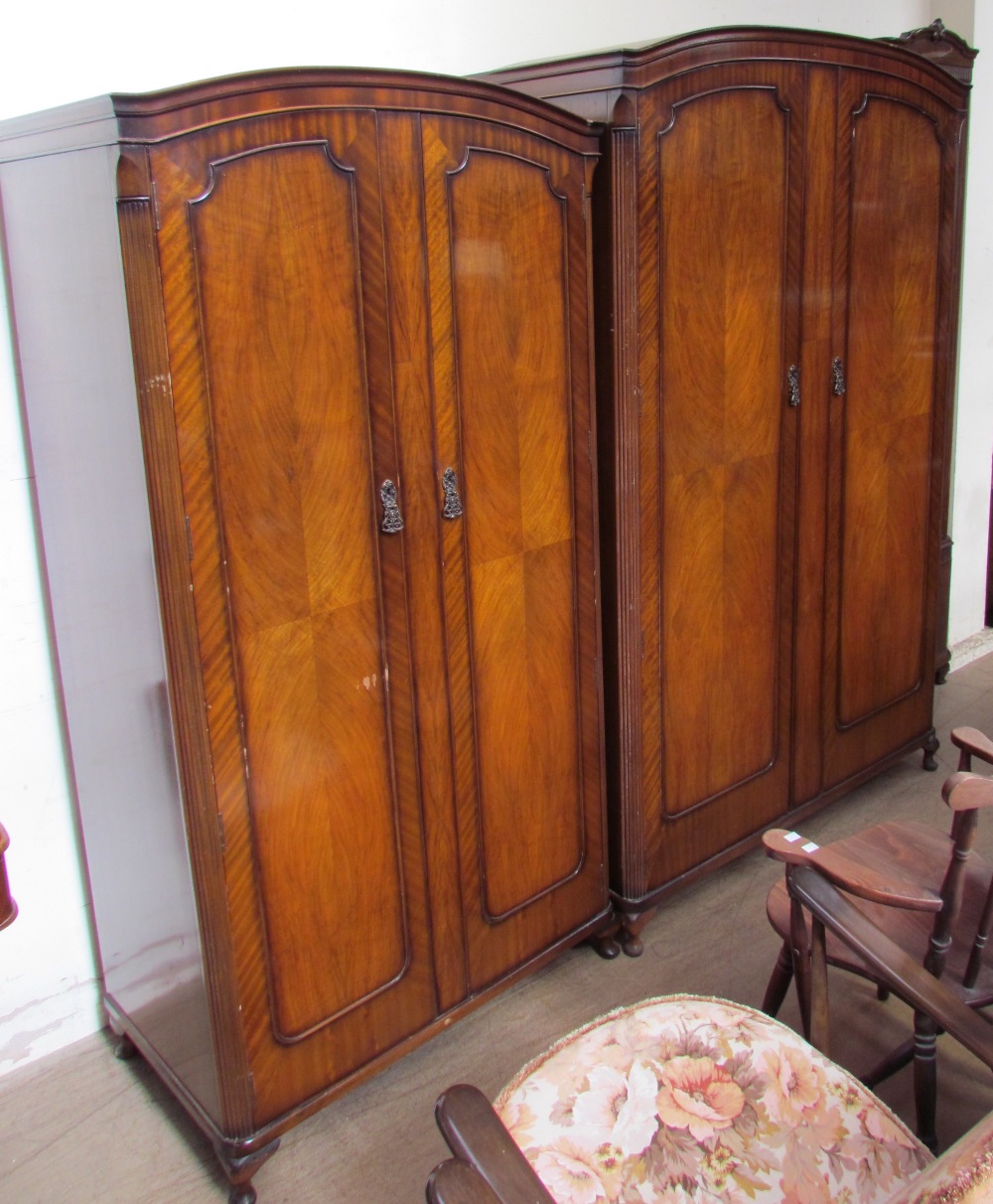 A Butilux walnut four piece bedroom suite comprising two wardrobes,