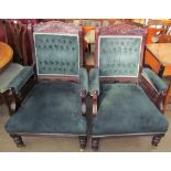 A pair of Edwardian upholstered library chairs with a carved cresting rail,
