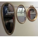 A gilt tear drop shaped wall mirror together with two other gilt decorated wall mirrors