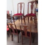 An oak extending dining table together with a set of six oak dining chairs