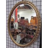 An oval gilt wall mirror together with a collection of mirrors and a photograph