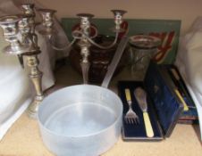 A pair of electroplated candelabra together with a cased carving set, cased fish servers, pan,