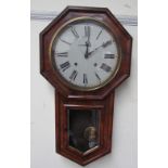 A Victorian walnut drop dial wall clock, of octagonal form with a glazed door and pointed base,