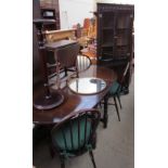 A 20th century oak gateleg dining table together with a set of four stick back chairs,