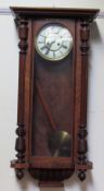 A Vienna regulator type wall clock, with a walnut case,