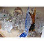 A large quantity of crystal drinking glasses together with glass birds,