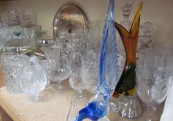 A large quantity of crystal drinking glasses together with glass birds,