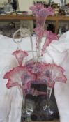 A Victorian pink glass epergne together with similar trumpet vases