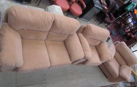 A tan leather three piece suite comprising a two seater settee and two armchairs