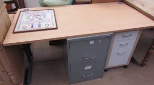 A modern desk together with a modern filing cabinet,