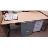 A modern desk together with a modern filing cabinet,