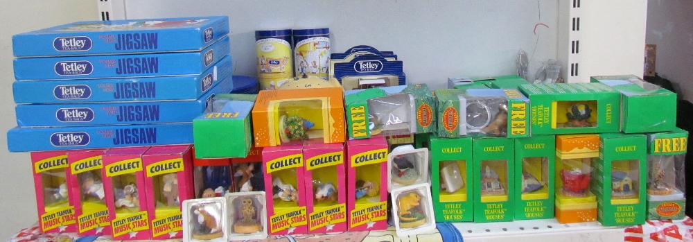 Assorted Tetley Tea related memorabilia including jigsaw puzzles, playing cards, clock, mugs,