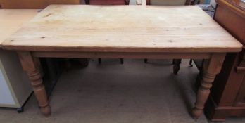 A pine scrub top kitchen dining table with a rectangular top and turned legs