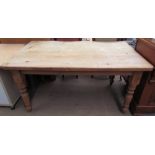 A pine scrub top kitchen dining table with a rectangular top and turned legs
