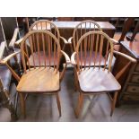 A set of four utility furniture elbow chairs