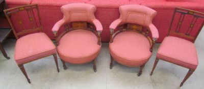 A pair of Edwardian mahogany upholstered horse shoe shaped elbow chairs together with a pair of