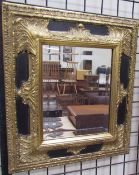 A gilt and ebonised wall mirror,