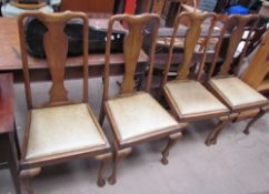 A set of four oak Queen Anne style dining chairs