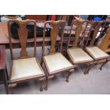 A set of four oak Queen Anne style dining chairs