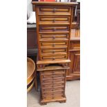 A pair of modern bedside cabinets each set with seven drawers on bracket feet