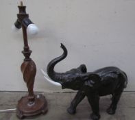 A pottery elephant together with a turned oak table lamp