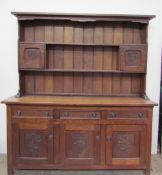 A 20th century oak dresser, the rack with a moulded cornice, shelves and cupboards,