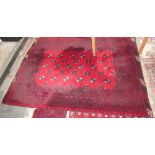 A red ground rug with alternating guls and stars