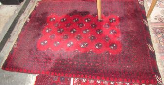 A red ground rug with alternating guls and stars