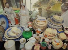 A Staffordshire figure of Queen Victoria and the Prince of Wales together with plates,