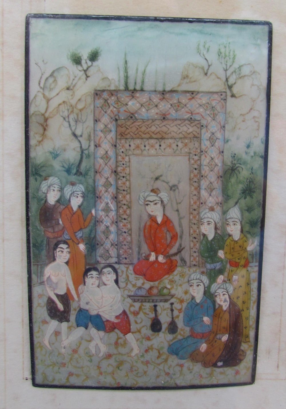 A miniature of an Indian figure group painted onto a mother of pearl panel,