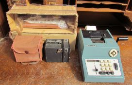 An adding machine together with Biloura camera and a model of the Artemis