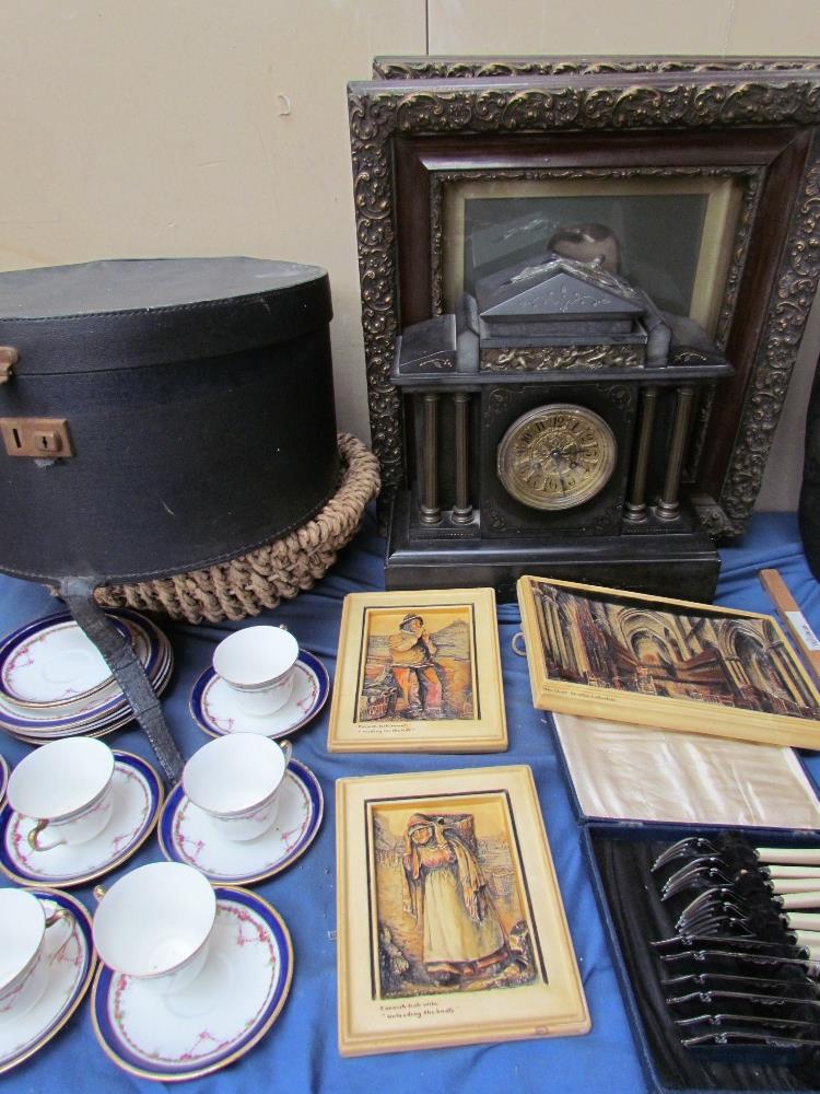 A pair of portrait photographs together with a black slate mantle clock, ivory panels, part tea set,