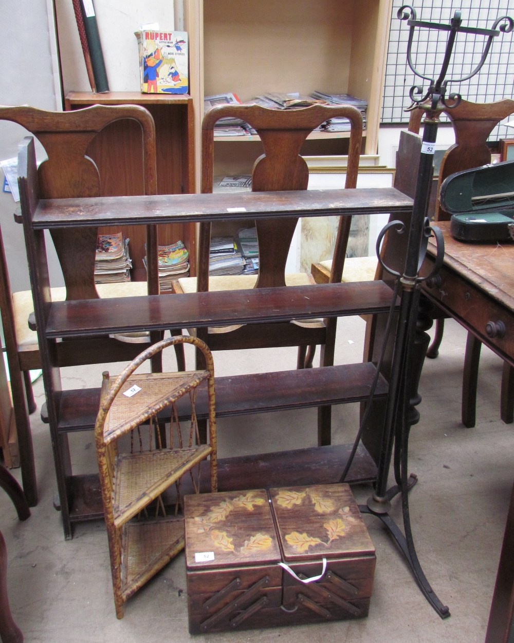 Hanging book shelves together with a Victorian cast iron telescopic standard lamp,