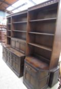 An Ercol dark elm and beech three section wall unit