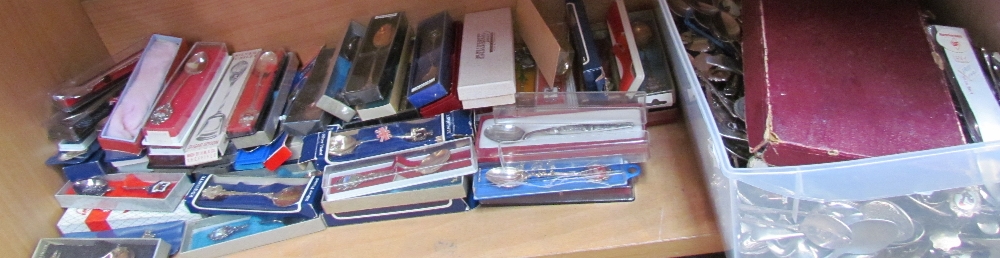 A large collection of souvenir spoons