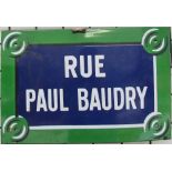 An enamel sign for Rue Paul Baudry together with an Alice in Wonderland plaque and assorted prints,