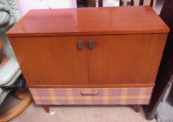 A teak side cabinet with a pair of cupboard doors together with a small pedestal desk