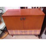 A teak side cabinet with a pair of cupboard doors together with a small pedestal desk
