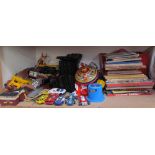 Assorted children's annuals and children books together with a magazine rack,