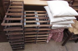 Three wine racks together with a stool and feather cushion pads