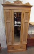 An Edwardian pine single door wardrobe together with a matching dressing table
