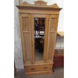 An Edwardian pine single door wardrobe together with a matching dressing table